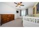 Cozy bedroom with neutral carpet, a ceiling fan, and a window at 4452 Bardsdale Dr, Palm Harbor, FL 34685