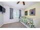 Well-lit bedroom featuring leafy green bedding, neutral carpet, and wall art at 4452 Bardsdale Dr, Palm Harbor, FL 34685
