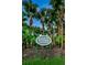 Lansbrook Commons sign amid lush greenery, emphasizing the private and exclusive nature of the community at 4452 Bardsdale Dr, Palm Harbor, FL 34685