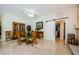 Dining area features display cabinet and easy access to the living area and sliding barn door at 4452 Bardsdale Dr, Palm Harbor, FL 34685