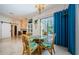 Charming dining area with views of outdoor pool area, and access to living room via sliding barn door at 4452 Bardsdale Dr, Palm Harbor, FL 34685