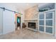 Living room features a fireplace with stone surround, sliding barn door, and built in shelving at 4452 Bardsdale Dr, Palm Harbor, FL 34685