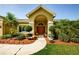 Inviting front entrance with well-maintained landscaping and charming details at 4452 Bardsdale Dr, Palm Harbor, FL 34685