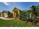 Home featuring mature landscaping and a lush green lawn at 4452 Bardsdale Dr, Palm Harbor, FL 34685