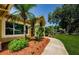 Home's sidewalk with mature landscaping leading to the front entrance at 4452 Bardsdale Dr, Palm Harbor, FL 34685