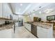 Bright kitchen with granite countertops, stainless steel appliances, and white cabinets for a modern feel at 4452 Bardsdale Dr, Palm Harbor, FL 34685
