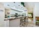Spacious kitchen featuring granite counters, white cabinets, pendant lighting, and an eat-in bar area at 4452 Bardsdale Dr, Palm Harbor, FL 34685