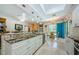 Modern kitchen with granite countertops, white cabinets, stainless steel appliances, and backyard views at 4452 Bardsdale Dr, Palm Harbor, FL 34685