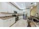 Well-equipped kitchen featuring granite counters, stainless steel appliances, and ample cabinet space at 4452 Bardsdale Dr, Palm Harbor, FL 34685