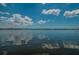 Tranquil lake view with reflective waters, expansive sky, and a distant shoreline evoke peacefulness at 4452 Bardsdale Dr, Palm Harbor, FL 34685