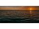 Stunning lake view captures a beautiful sunset reflecting on the calm water at 4452 Bardsdale Dr, Palm Harbor, FL 34685