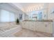 Bright bathroom featuring a large vanity, soaking tub, and a neutral color scheme at 4452 Bardsdale Dr, Palm Harbor, FL 34685