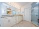 Modern bathroom boasts a double vanity, a glass shower, and tiled floors at 4452 Bardsdale Dr, Palm Harbor, FL 34685