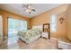 Bright main bedroom boasts access to the pool area, tiled floors, and neutral wall colors at 4452 Bardsdale Dr, Palm Harbor, FL 34685