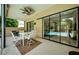 Covered patio with table set and chairs, overlooking the pool through sliding glass doors at 4452 Bardsdale Dr, Palm Harbor, FL 34685