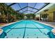 The screened-in pool and patio with a dining table is perfect for outdoor living at 4452 Bardsdale Dr, Palm Harbor, FL 34685