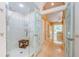 Modern tiled shower with a glass door, a seat, and a decorative tiled pattern at 4452 Bardsdale Dr, Palm Harbor, FL 34685