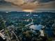 Gorgeous aerial view showing homes nestled among trees, roads, lakes, and the ocean at sunset at 4805 Alt 19 # 421, Palm Harbor, FL 34683