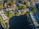 Expansive aerial view showcasing a neighborhood with lake access and a community pool at 4805 Alt 19 # 421, Palm Harbor, FL 34683
