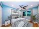 Bright bedroom featuring a ceiling fan, light blue walls, and stylish decor at 4805 Alt 19 # 421, Palm Harbor, FL 34683