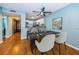 Stylish dining area with a modern table, chairs, and a ceiling fan, adjacent to the kitchen at 4805 Alt 19 # 421, Palm Harbor, FL 34683