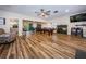 Spacious game room with hardwood floors, pool table, ceiling fan, and a comfortable seating area at 4805 Alt 19 # 421, Palm Harbor, FL 34683