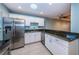 Well-lit kitchen featuring stainless steel appliances, white cabinets, and black granite countertops at 4805 Alt 19 # 421, Palm Harbor, FL 34683