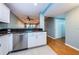 Open kitchen area features white cabinets, granite countertops and stainless steel dishwasher at 4805 Alt 19 # 421, Palm Harbor, FL 34683