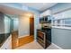Eat-in kitchen with tile and wood floors, stainless steel appliances and lots of natural light at 4805 Alt 19 # 421, Palm Harbor, FL 34683
