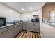 Kitchenette area featuring modern appliances, granite countertop, and cabinetry at 4805 Alt 19 # 421, Palm Harbor, FL 34683