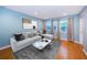 Comfortable living room with sofa, marble coffee table, and windows offering ample natural light at 4805 Alt 19 # 421, Palm Harbor, FL 34683