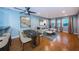 Open-concept living area with dining table, modern sectional sofa, and large windows at 4805 Alt 19 # 421, Palm Harbor, FL 34683
