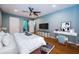 This spacious main bedroom features stylish decor, ceiling fan, and hard wood floors at 4805 Alt 19 # 421, Palm Harbor, FL 34683