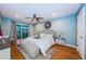 Bright main bedroom with ceiling fan, a mirrored accent piece, and sliding glass doors to a balcony at 4805 Alt 19 # 421, Palm Harbor, FL 34683