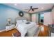 Spacious main bedroom features ceiling fan, wood floors, and ensuite bathroom entrance at 4805 Alt 19 # 421, Palm Harbor, FL 34683