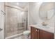 Well-lit bathroom with a modern vanity, framed mirror, and a tiled walk-in shower at 4808 Jackson Club Loop, Tampa, FL 33624