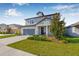 Charming two-story home features a well-manicured lawn, attached garage, and inviting entryway at 4808 Jackson Club Loop, Tampa, FL 33624