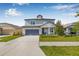 Charming two-story home features a well-manicured lawn, attached garage, and inviting entryway at 4808 Jackson Club Loop, Tampa, FL 33624