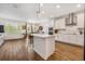 Bright, open kitchen with large island, pendant lighting, and stainless-steel appliances at 4808 Jackson Club Loop, Tampa, FL 33624