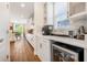 Bright kitchen area featuring white cabinets, stainless steel appliances, and a wine cooler at 4808 Jackson Club Loop, Tampa, FL 33624