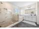 Luxurious bathroom with a glass shower and soaking tub, complemented by white marble accents at 4808 Jackson Club Loop, Tampa, FL 33624