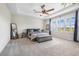 Spacious main bedroom with large windows, tray ceiling, and neutral tones for a relaxing retreat at 4808 Jackson Club Loop, Tampa, FL 33624