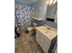 Cozy bathroom featuring a decorative shower curtain and a bright vanity area at 4851 W Gandy Blvd # B3L12, Tampa, FL 33611