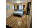 Relaxing bedroom featuring natural light and wood-look laminate flooring at 4851 W Gandy Blvd # B3L12, Tampa, FL 33611