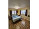 Cozy bedroom with a comfortable bed, lots of natural light, and wood-look laminate floors at 4851 W Gandy Blvd # B3L12, Tampa, FL 33611