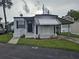 Charming single story home featuring an awning and a small landscaped garden area at 4851 W Gandy Blvd # B3L12, Tampa, FL 33611