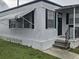 Quaint front porch and door of this single story home features a small garden at 4851 W Gandy Blvd # B3L12, Tampa, FL 33611