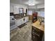 Bright kitchen featuring white cabinetry, stainless steel sink, and a dining table at 4851 W Gandy Blvd # B3L12, Tampa, FL 33611