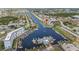 Stunning aerial view of waterfront condos with canal access, lush landscaping, boat docks, and serene water views at 5157 Silent Loop # 214, New Port Richey, FL 34652