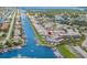 Drone shot displays waterfront condos with boating access to canals, lush landscaping, and serene water views at 5157 Silent Loop # 214, New Port Richey, FL 34652